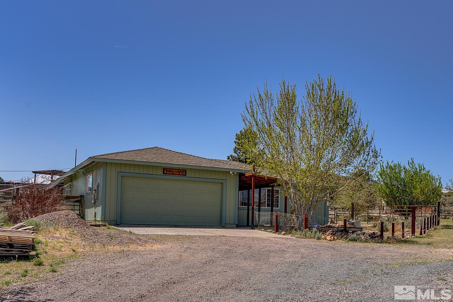 16015 Rocky Vista Road Reno, NV 89521 - Photo 1 of 20 a front view of a house with a yard and garage
