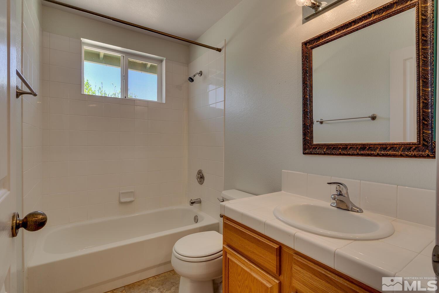 16015 Rocky Vista Road Reno, NV 89521 - Photo 13 of 20 a bathroom with a sink and a mirror