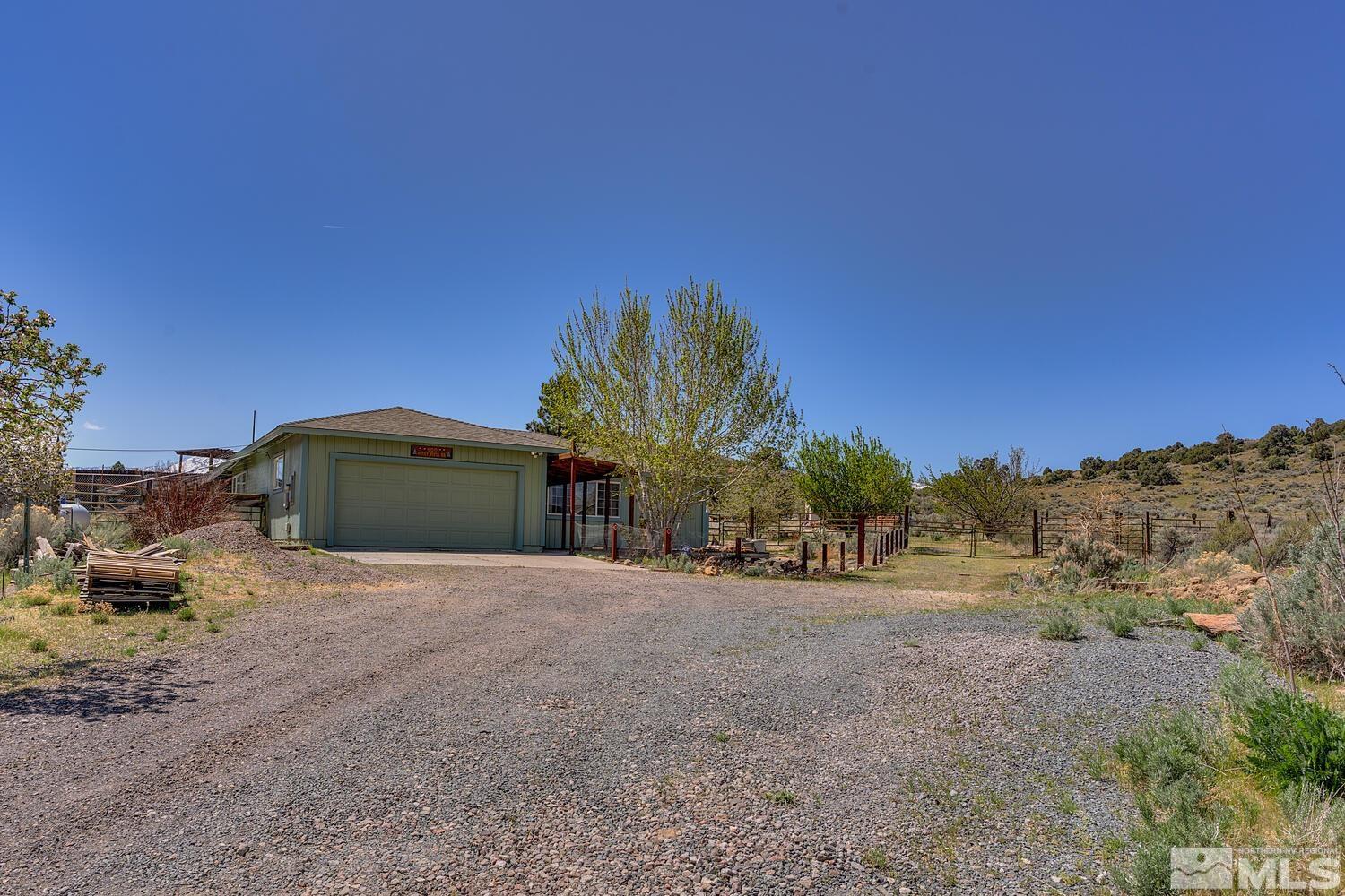 16015 Rocky Vista Road Reno, NV 89521 - Photo 2 of 20 a front view of a house with a yard and garage