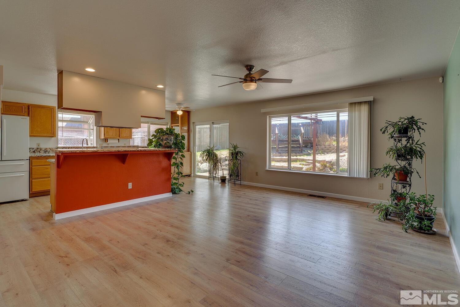 16015 Rocky Vista Road Reno, NV 89521 - Photo 5 of 20 a view of a kitchen with furniture a ceiling fan and wooden floor