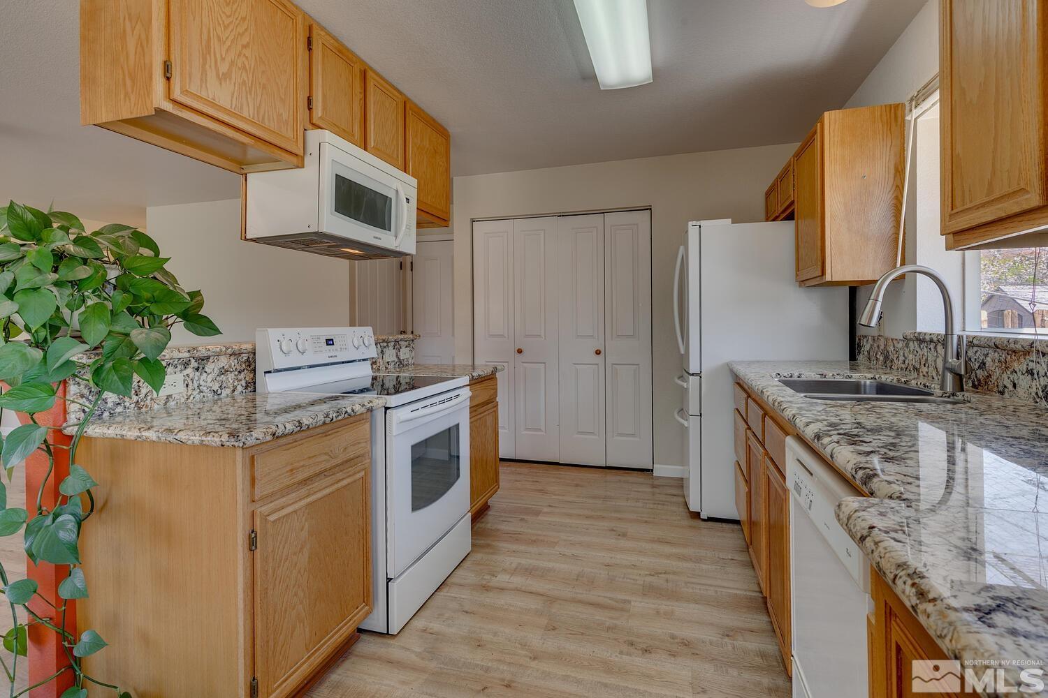 16015 Rocky Vista Road Reno, NV 89521 - Photo 8 of 20 a kitchen with stainless steel appliances granite countertop a stove a sink and a refrigerator
