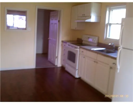 a kitchen with a sink cabinets and a window