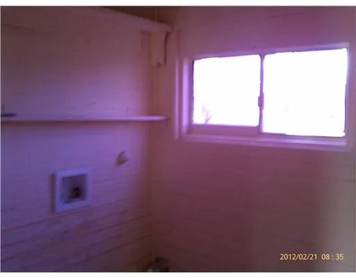 a view of a livingroom with an empty space and a window