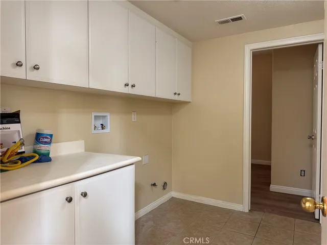 a view of kitchen with white cabinets