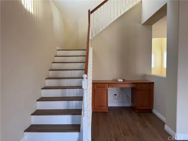 a view of entryway and hall with wooden floor