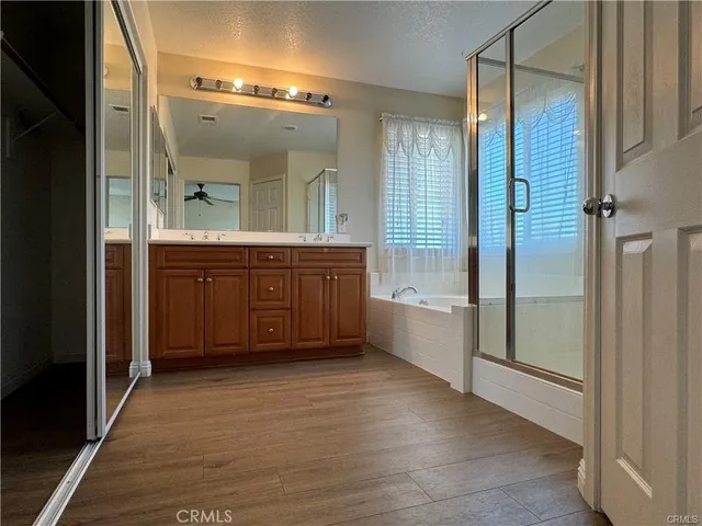 a bathroom with a tub mirror and sink