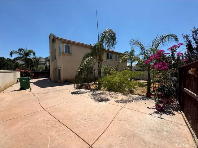 a view of a house with potted plants