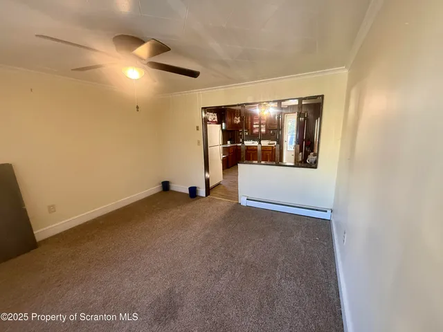 a view of a room with a hanging light and fireplace