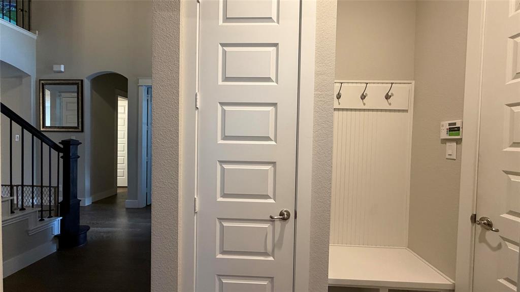 912 Fallbrook Avenue Denton, TX 76210 - Photo 23 of 26 a view of a hallway with wooden floor and staircase