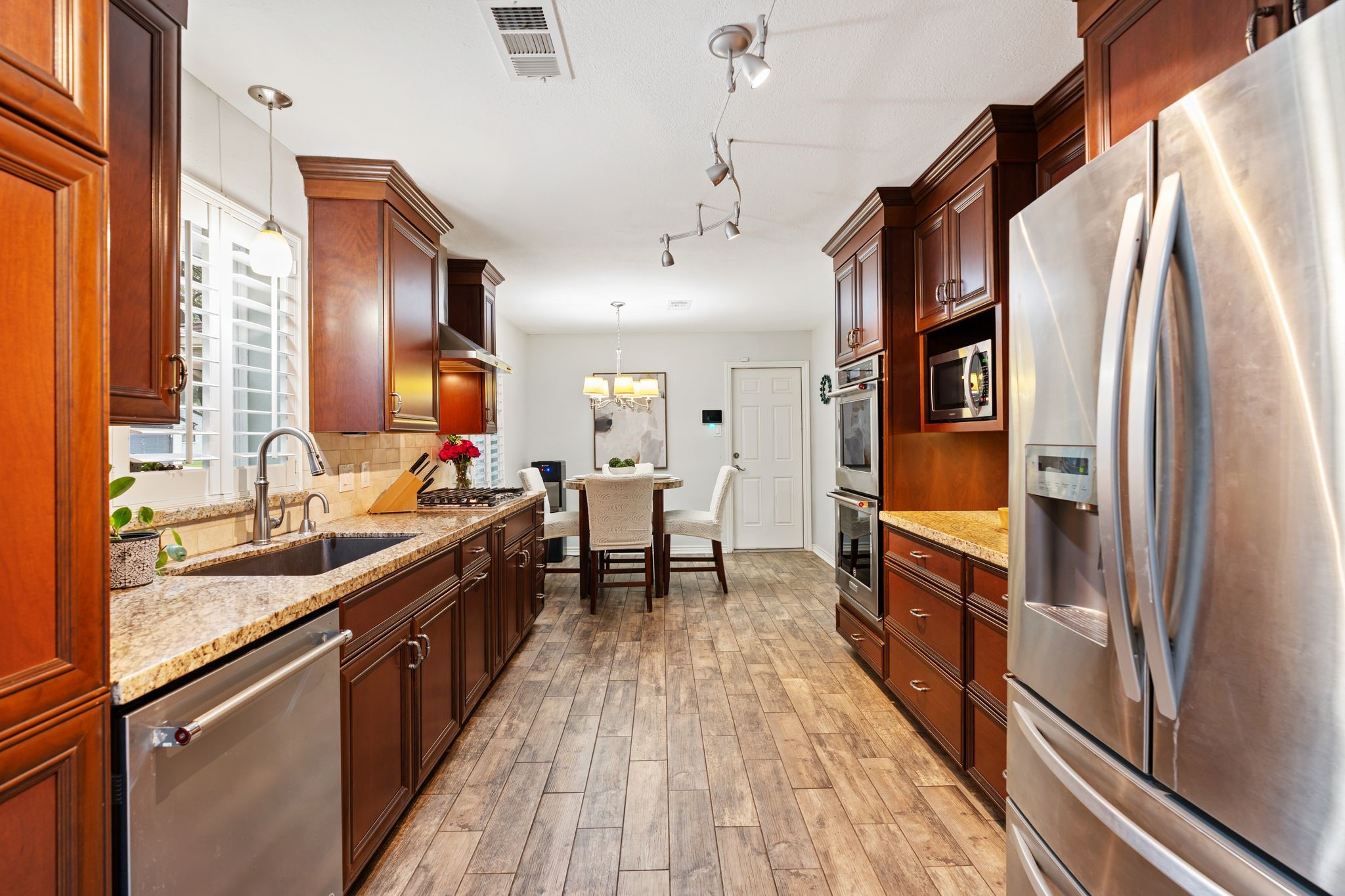 5658 Cartagena Street Houston, TX 77035 - Photo 11 of 33 Kitchen amenities include an instant hot water spout, double convection ovens, and 3 tier dishwasher.