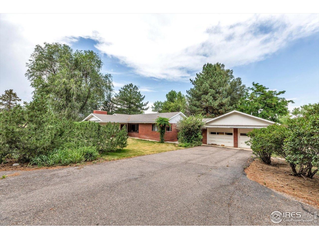 5273 Independence Road Boulder, CO 80301 - Photo 11 of 16 a front view of a house with a yard and garage