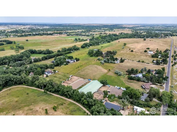 an aerial view of residential houses with outdoor space and river