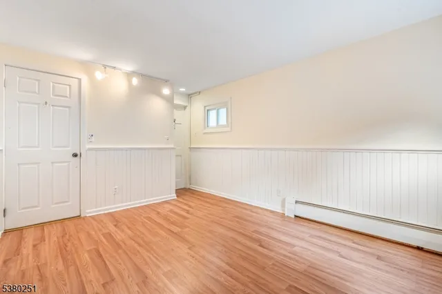 an empty room with wooden floor