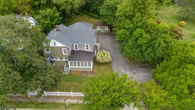 an aerial view of a house with a yard basket ball court and outdoor seating