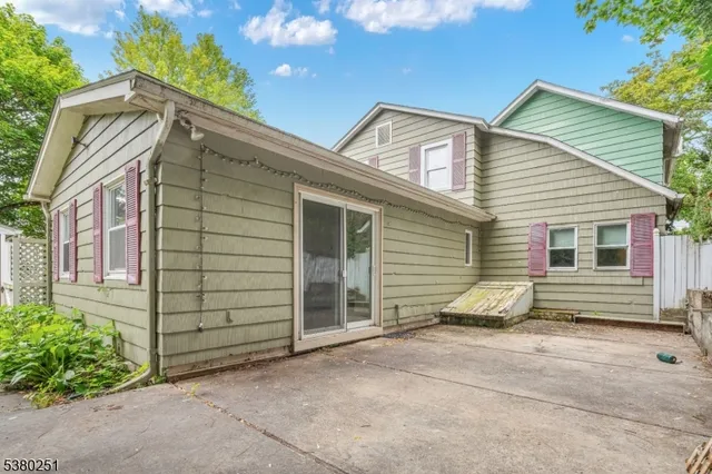 a view of a house with a garage and yard