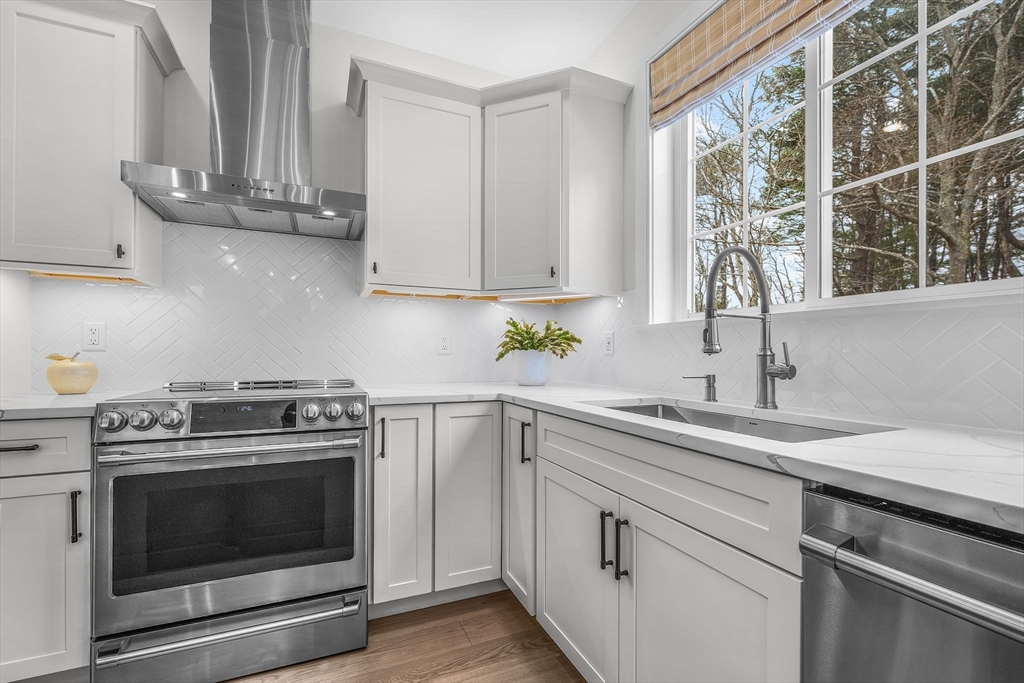 28 Oxbow Road, Unit 142 Raynham, MA 02767 - Photo 12 of 42 a kitchen with stainless steel appliances granite countertop a sink a stove and a window