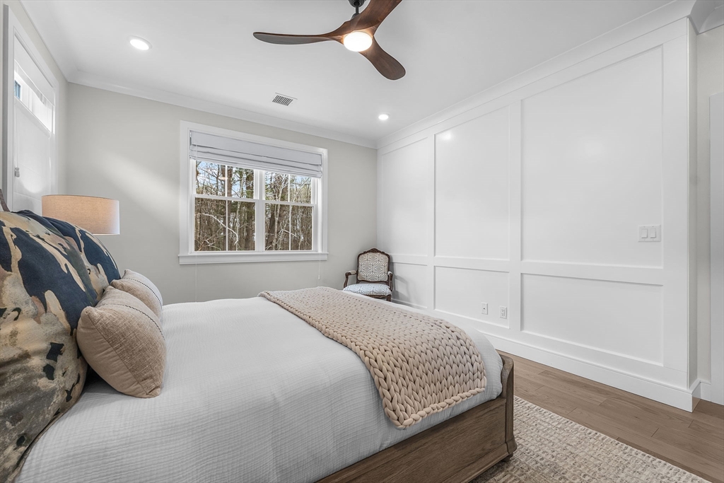 28 Oxbow Road, Unit 142 Raynham, MA 02767 - Photo 16 of 42 a bedroom with a bed and wooden floor