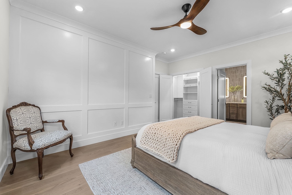 28 Oxbow Road, Unit 142 Raynham, MA 02767 - Photo 17 of 42 a spacious bedroom with a bed and a chandelier