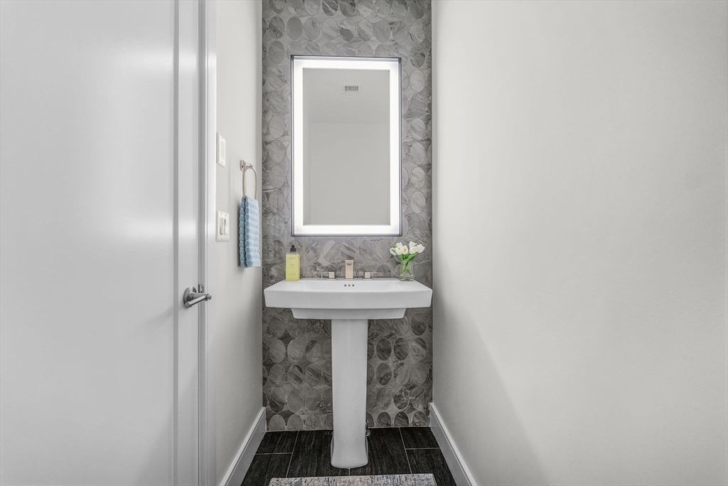 28 Oxbow Road, Unit 142 Raynham, MA 02767 - Photo 25 of 42 a bathroom with a sink and a mirror