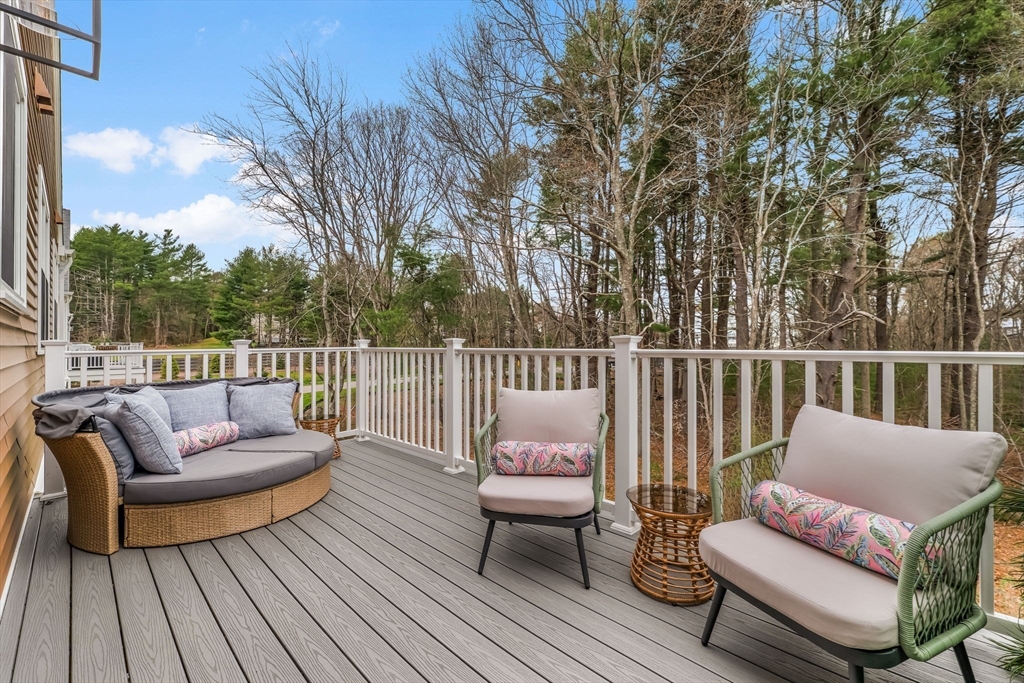 28 Oxbow Road, Unit 142 Raynham, MA 02767 - Photo 27 of 42 a balcony with wooden floor and furniture