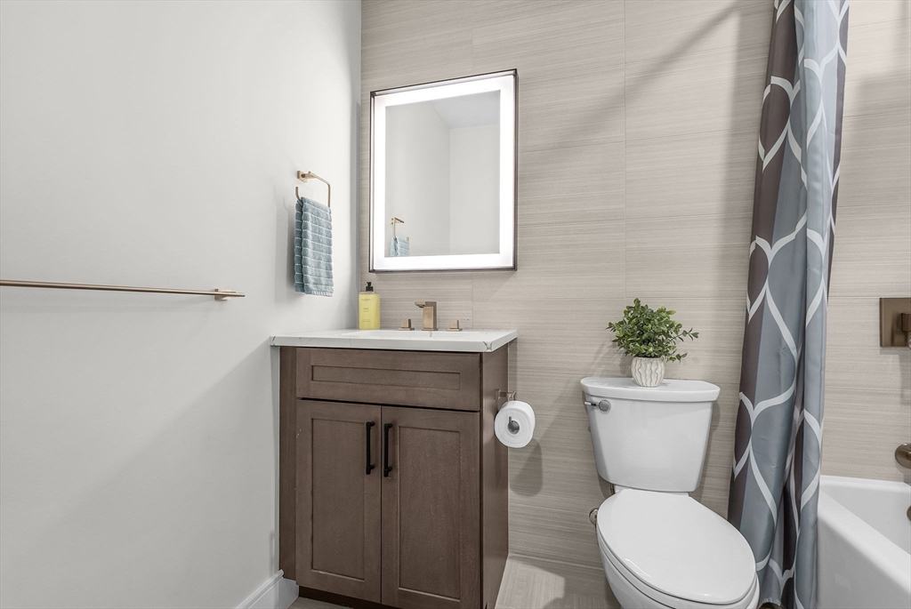 28 Oxbow Road, Unit 142 Raynham, MA 02767 - Photo 31 of 42 a bathroom with a toilet a sink and mirror