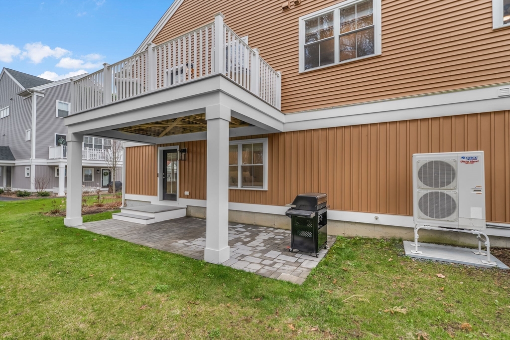 28 Oxbow Road, Unit 142 Raynham, MA 02767 - Photo 38 of 42 a backyard of a house with barbeque oven