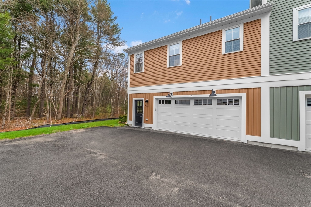 28 Oxbow Road, Unit 142 Raynham, MA 02767 - Photo 5 of 42 a view of a house with a yard and garage
