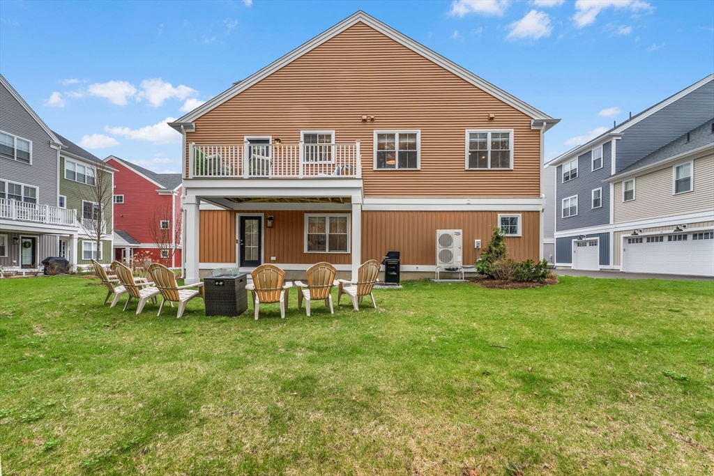 28 Oxbow Road, Unit 142 Raynham, MA 02767 - Photo 6 of 42 a front view of house with yard and outdoor seating