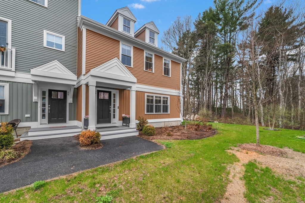 28 Oxbow Road, Unit 142 Raynham, MA 02767 - Photo 7 of 42 a front view of a house with garden and porch