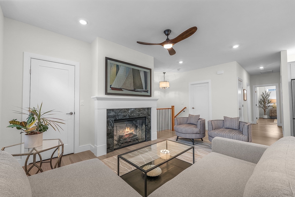 28 Oxbow Road, Unit 142 Raynham, MA 02767 - Photo 9 of 42 a living room with furniture and a fireplace