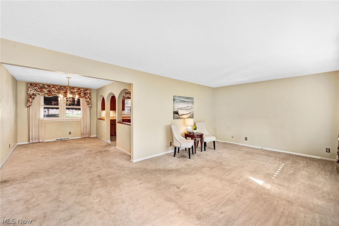 6452 Carsten Road Medina, OH 44256 - Photo 4 of 41 Unfurnished room with an inviting chandelier and light carpet