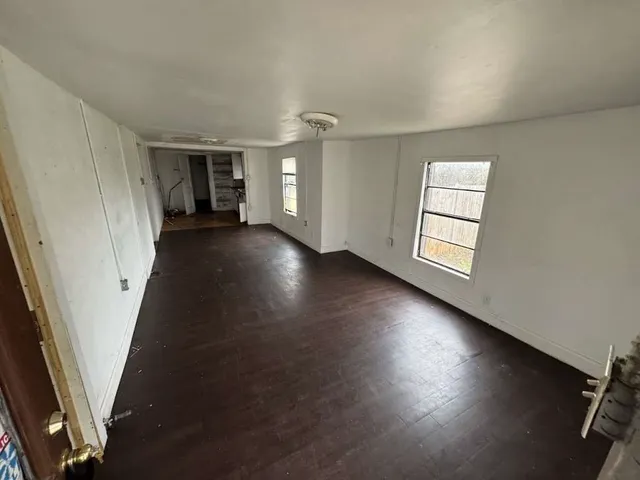an empty room with windows and closet