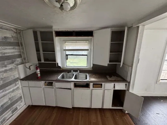 a kitchen with wooden cabinets and a sink