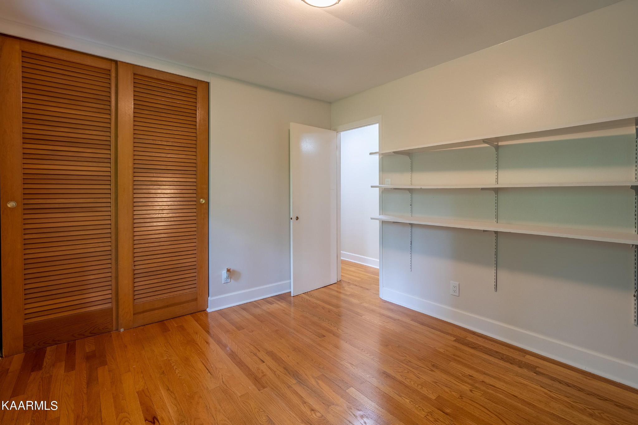 103 Canterbury Road Oak Ridge, TN 37830 - Photo 11 of 27 a view of an empty room with a window and wooden floor