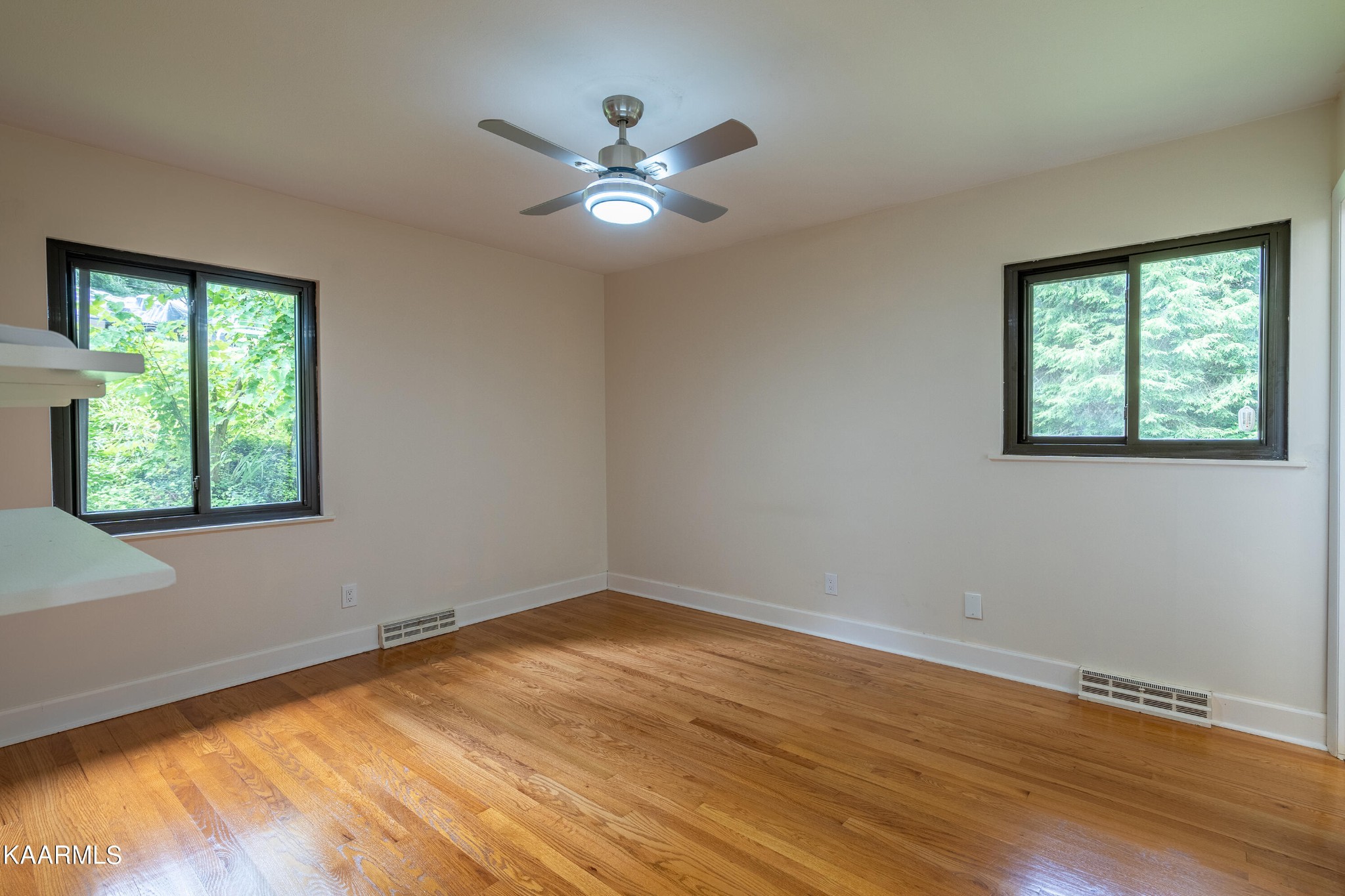 103 Canterbury Road Oak Ridge, TN 37830 - Photo 12 of 27 a view of an empty room with wooden floor and a window
