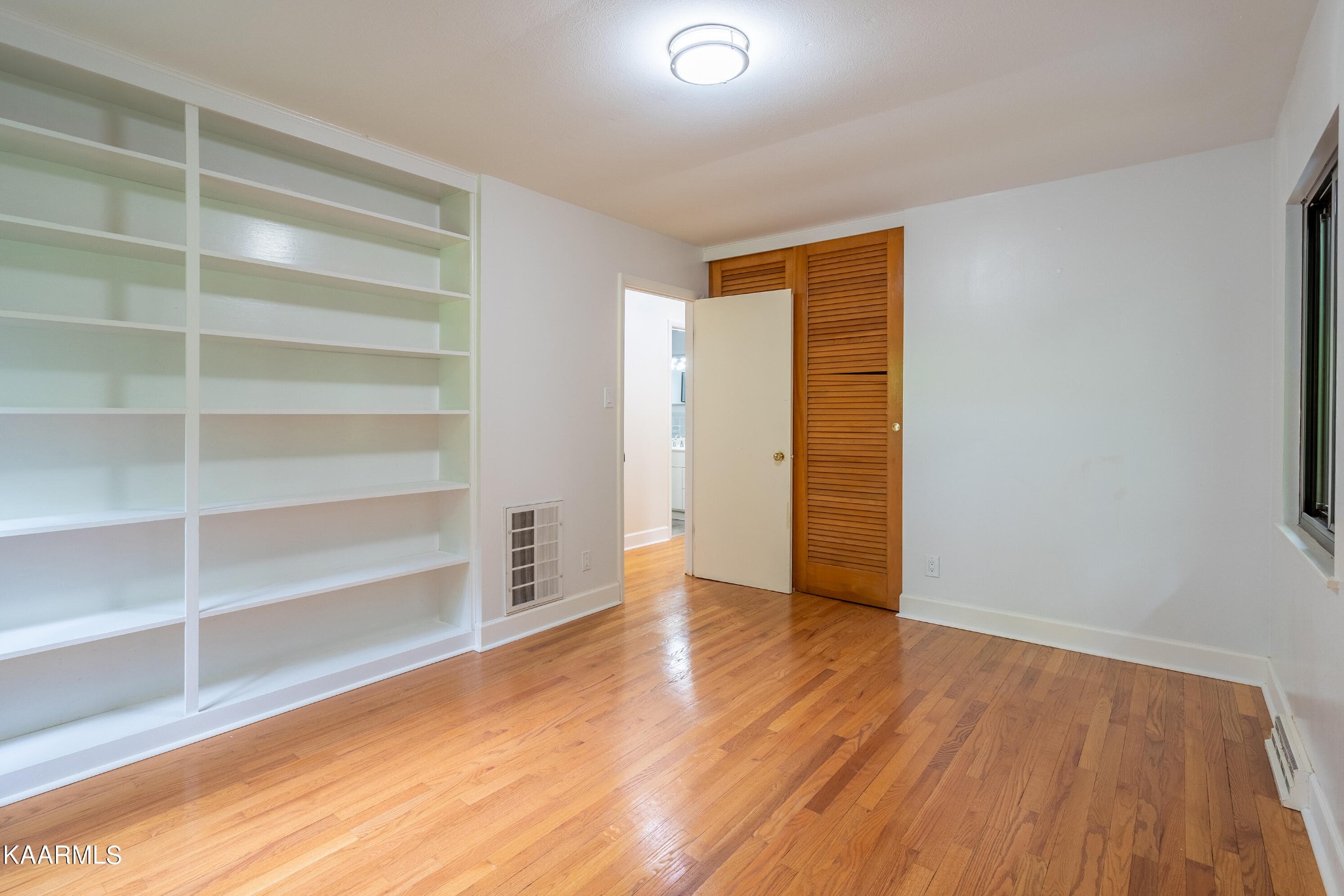 103 Canterbury Road Oak Ridge, TN 37830 - Photo 13 of 27 a view of an empty room with a window and wooden floor