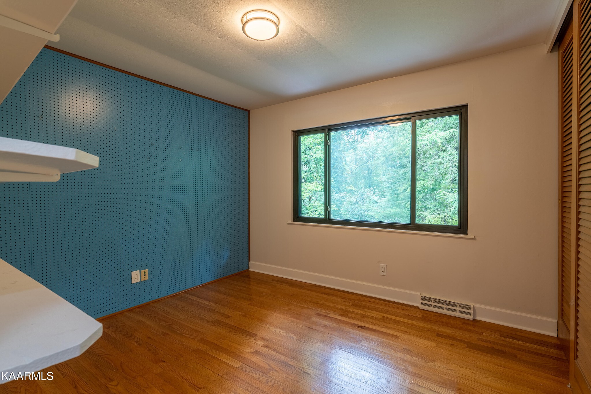103 Canterbury Road Oak Ridge, TN 37830 - Photo 14 of 27 an empty room with wooden floor and windows