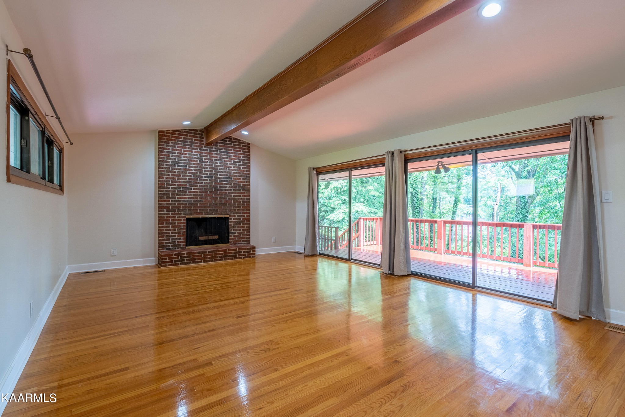 103 Canterbury Road Oak Ridge, TN 37830 - Photo 2 of 27 a view of empty room with wooden floor and fireplace
