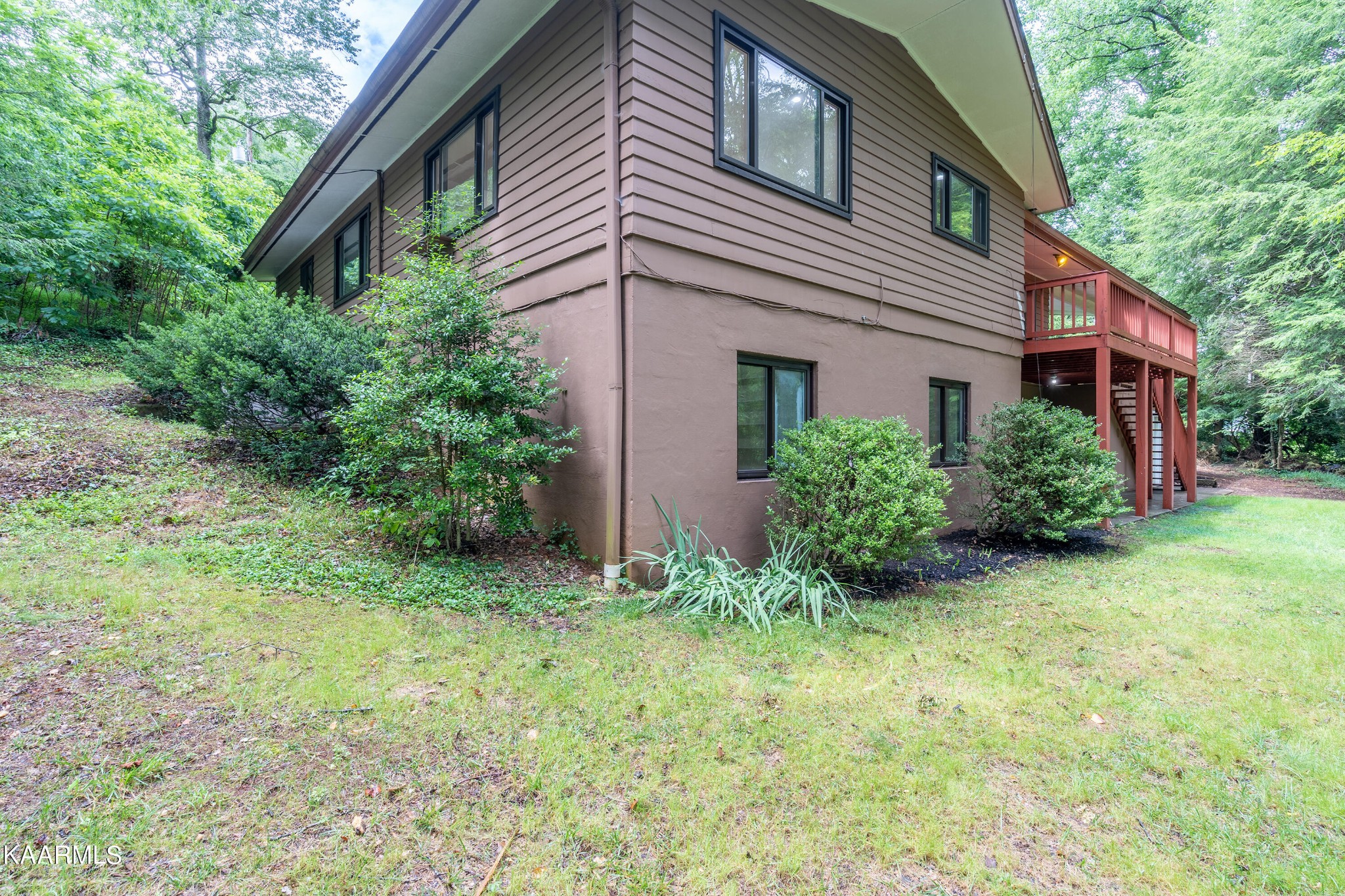 103 Canterbury Road Oak Ridge, TN 37830 - Photo 24 of 27 a view of a house with brick walls and a yard with plants
