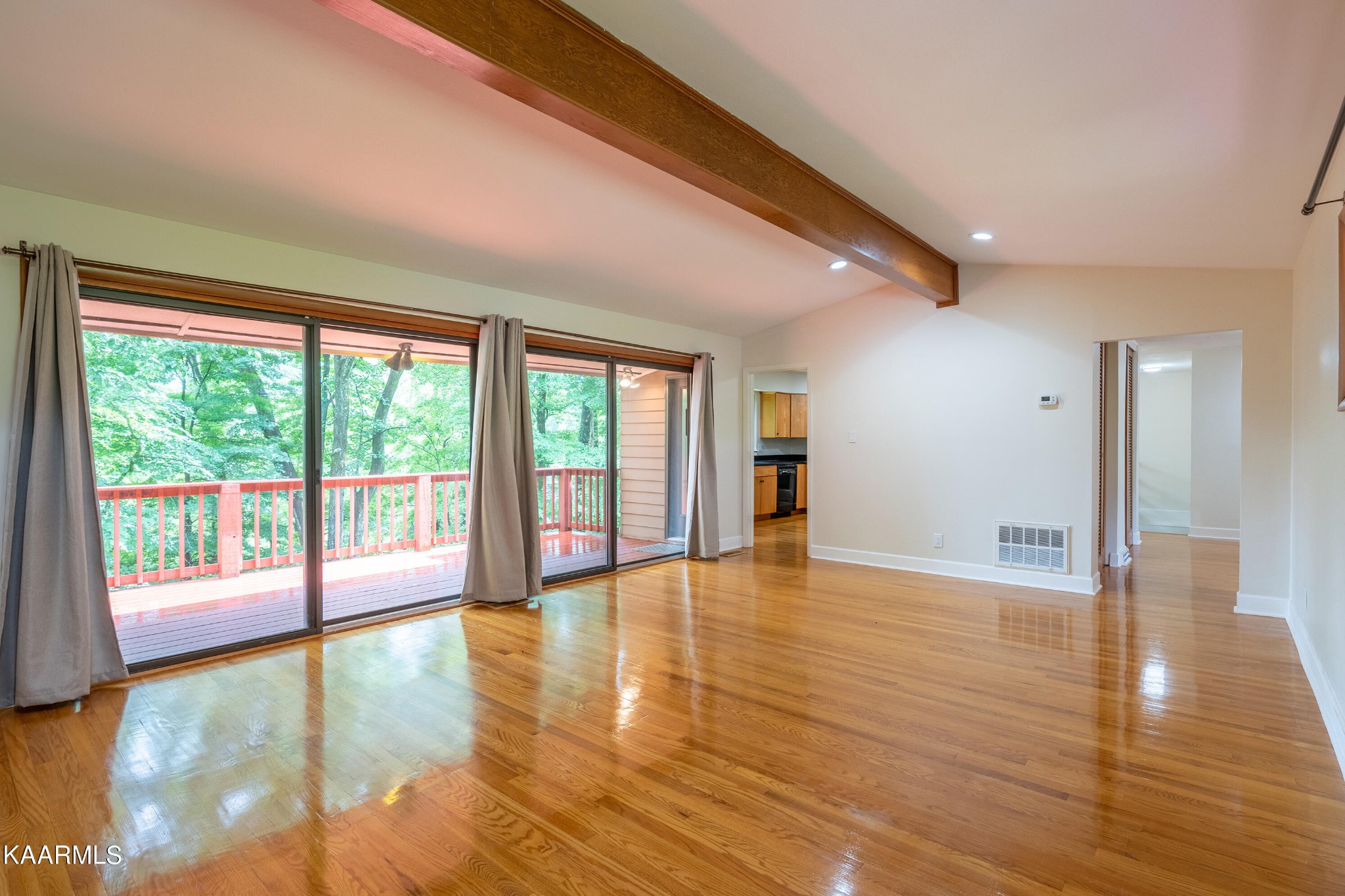 103 Canterbury Road Oak Ridge, TN 37830 - Photo 3 of 27 a view of an empty room with wooden floor and a window