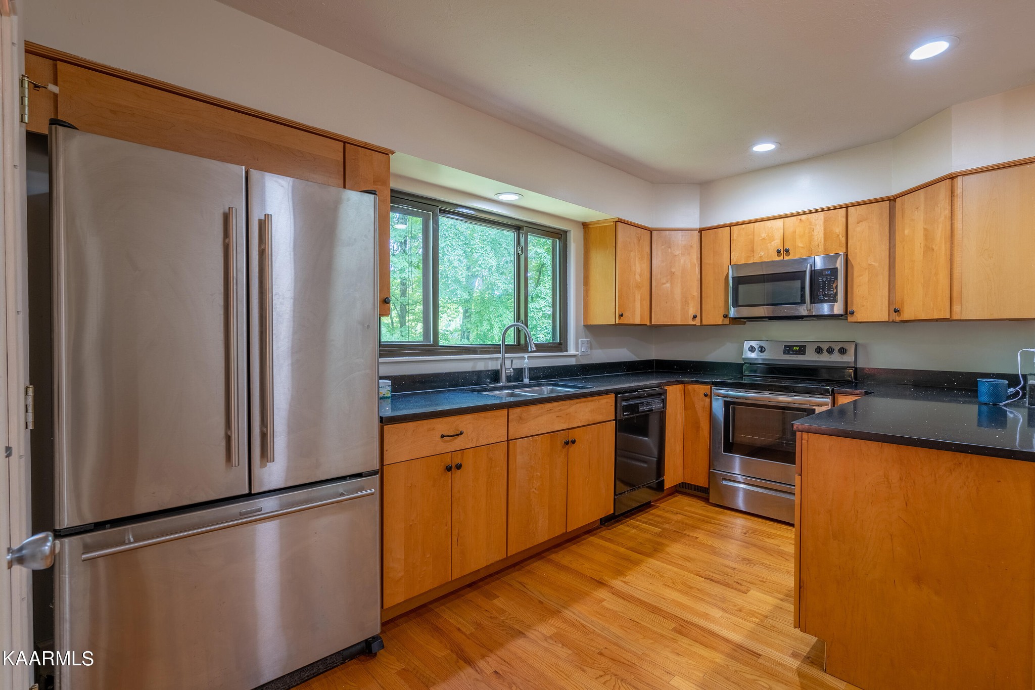 103 Canterbury Road Oak Ridge, TN 37830 - Photo 4 of 27 a kitchen with stainless steel appliances granite countertop a refrigerator stove top oven and sink