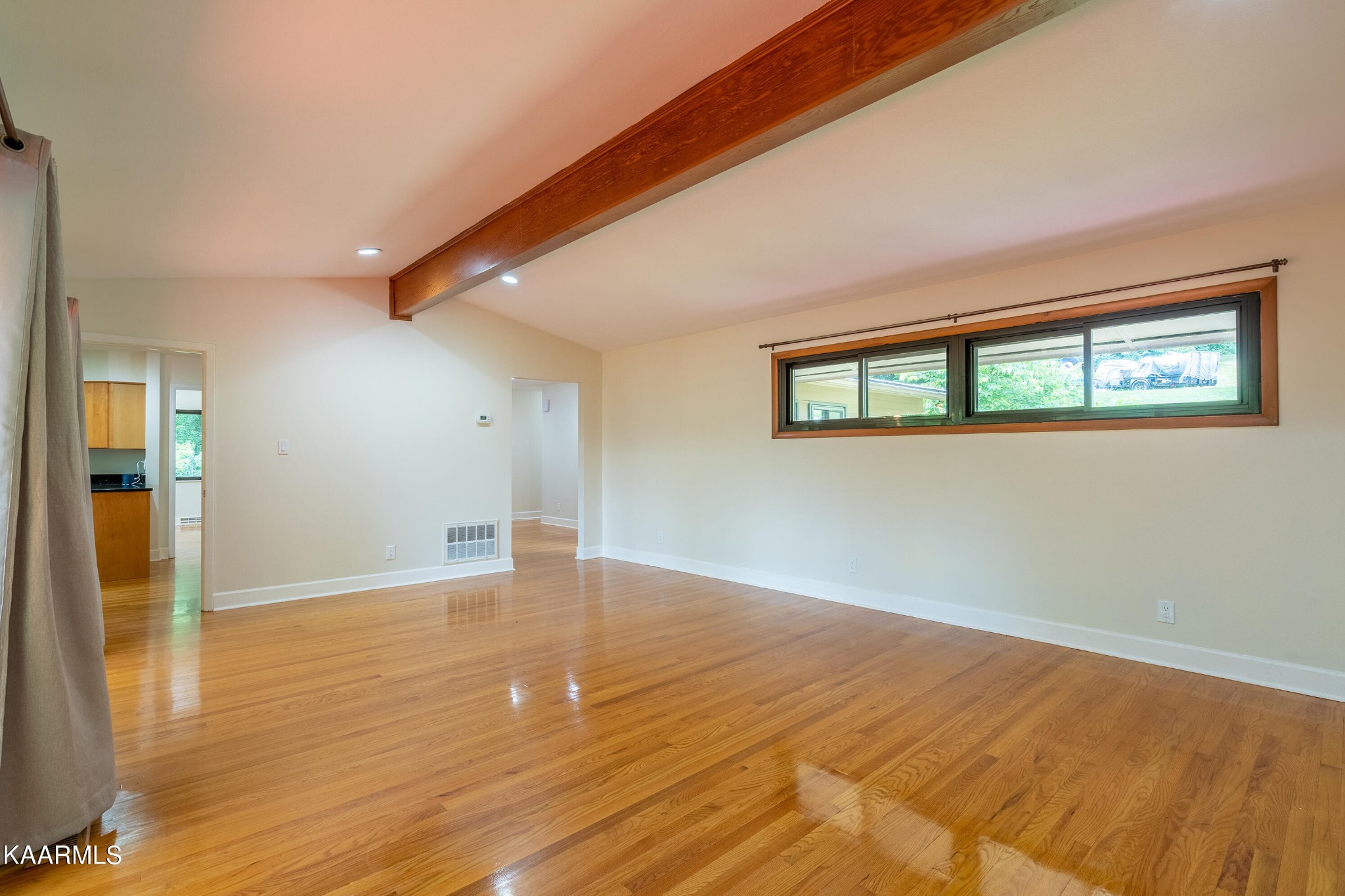103 Canterbury Road Oak Ridge, TN 37830 - Photo 8 of 27 a view of an empty room with wooden floor and a window