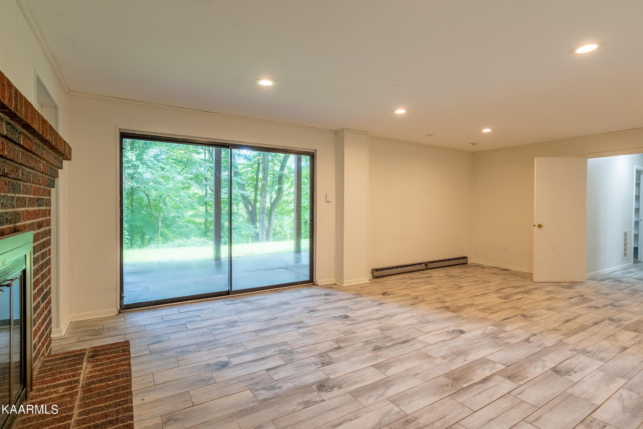 103 Canterbury Road Oak Ridge, TN 37830 - Photo 9 of 27 a view of empty room with wooden floor and fan
