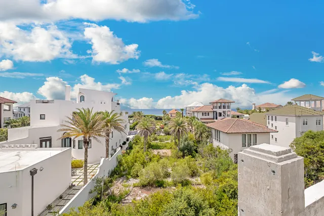 a living room with large couches and kitchen view