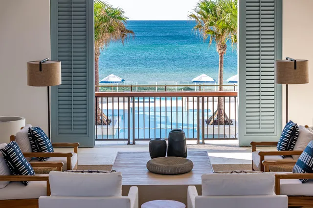 a view of a rooftop deck with chairs and wooden floor