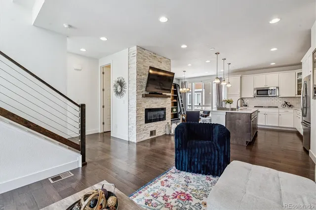 a living room with stainless steel appliances furniture or kitchen view and living room view