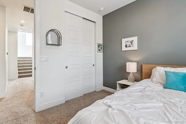 a bedroom with a bed and a night stand