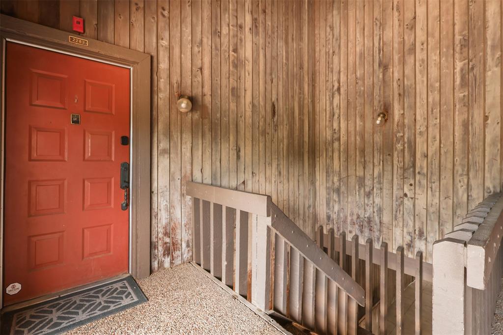 a view of a porch with a table and chairs