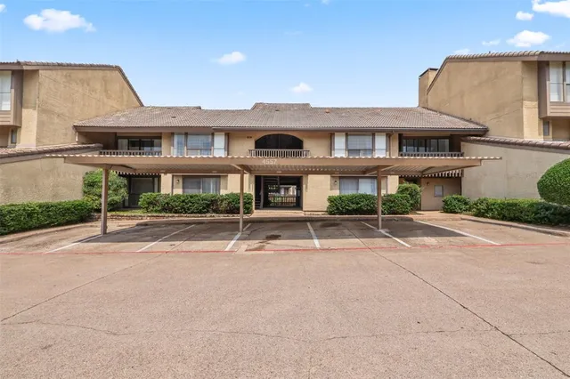 a front view of a house with a yard and potted plants