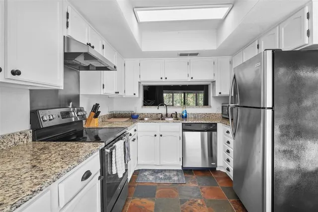 a kitchen with a sink stove and refrigerator